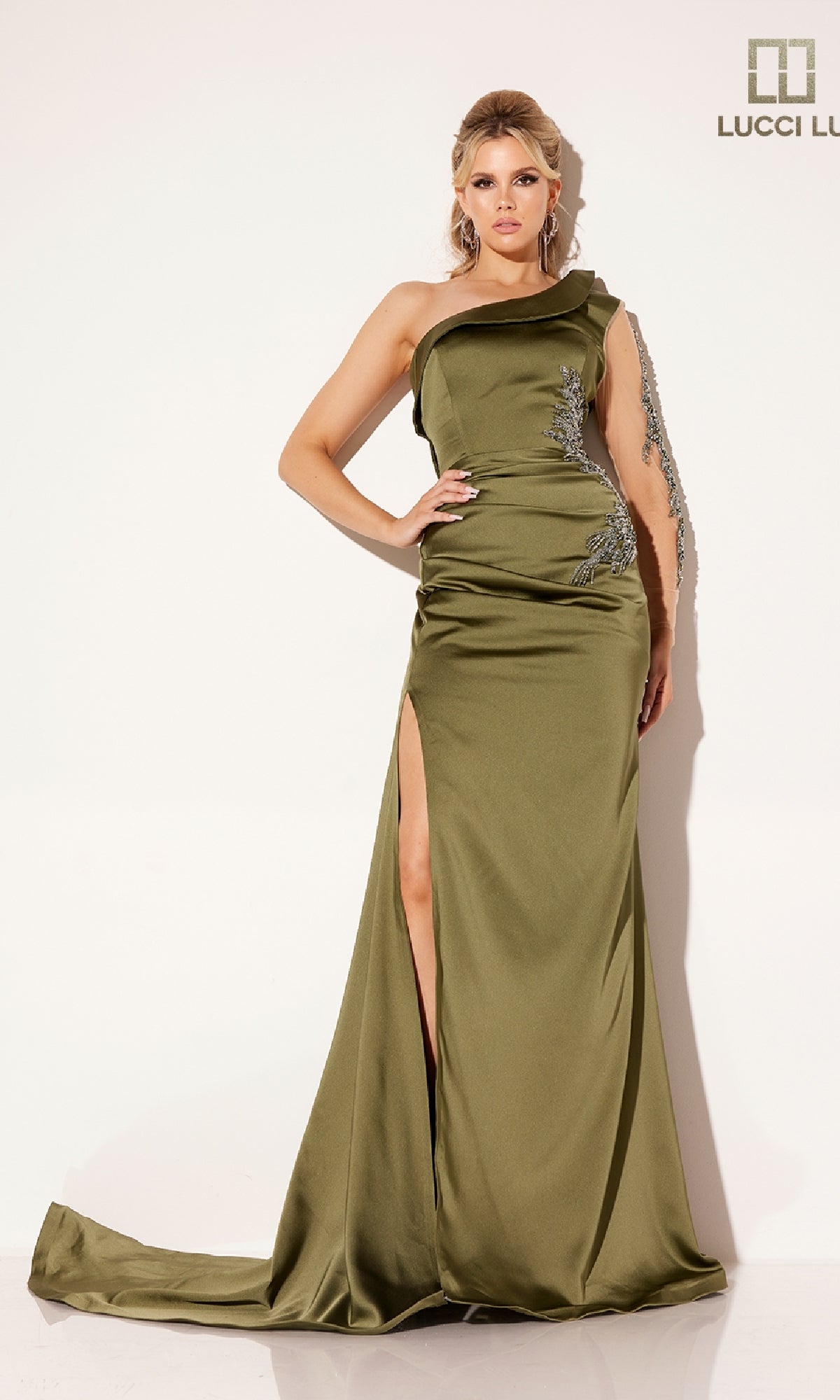 A woman models the Lucci Lu C8094, a floor-length olive green one-shoulder formal dress with a thigh-high slit and silver embellishments, set against a plain white background.